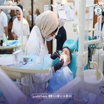 Pediatric dentist and assistant examine a childs teeth in a brightly lit clinic for a check up or treatment   جامعة الرافدين   مدير الموقع عمار محمود ابو الشعير   جامعة الرافدين   مدير الموقع عمار محمود ابو الشعير